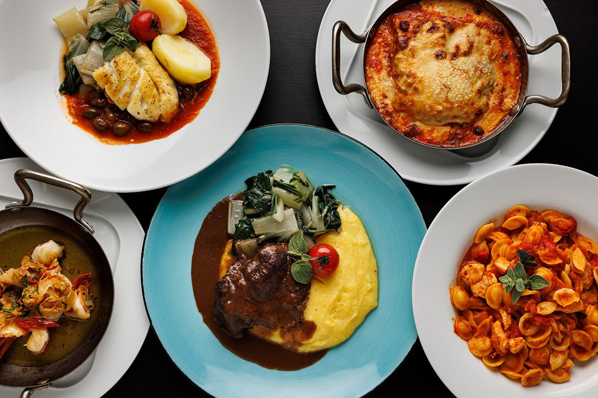 Verschiedene italienische Gerichte serviert auf bunten Tellern im Ristorante Mercato in Kloten.